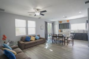 a living room with a couch and a table at 2400SqFt House 6beds 3bath Pool table BBQ in Las Vegas