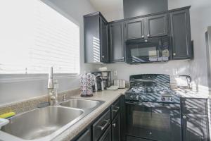 a kitchen with a sink and a stove at 2400SqFt House 6beds 3bath Pool table BBQ in Las Vegas
