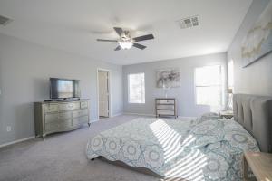 a bedroom with a bed and a flat screen tv at 2400SqFt House 6beds 3bath Pool table BBQ in Las Vegas