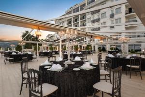 a restaurant with tables and chairs and a building at La Quinta by Wyndham Giresun in Giresun