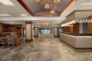a lobby with a bar and tables and chandeliers at La Quinta by Wyndham Giresun in Giresun +199 photos