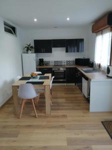 a kitchen with a wooden table and a dining room at Fresi Gustave in Levie