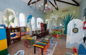 a room with a classroom with tables and chairs at Odyssee Resort Thalasso & SPA in Zarzis