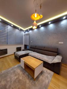 a living room with a couch and a coffee table at Apartman Grey in Zlatibor