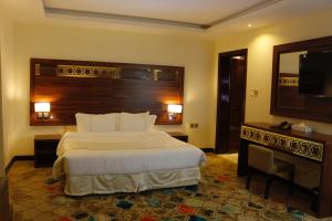 מיטה או מיטות בחדר ב-Central Park Hotel Bisha
