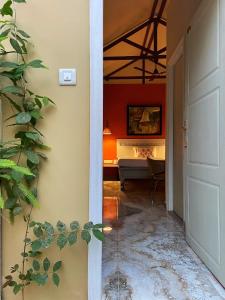 a hallway leading to a bedroom with a bed at The Art Hotel by VIA VARANASI in Varanasi