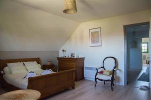 - une chambre avec un lit, une chaise et une table dans l'établissement Appartement en campagne a 1h30 de Paris, à Foucrainville