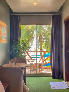 a room with a table and a window with a view at Maamadi Boutique in Maafushi