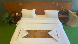 a bedroom with a large white bed with white pillows at Maamadi Boutique in Maafushi