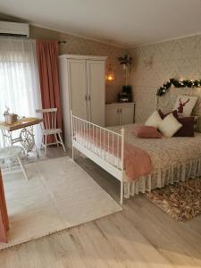 a bedroom with a bed with a crib and a table at Holiday Home Kolka in Kolka