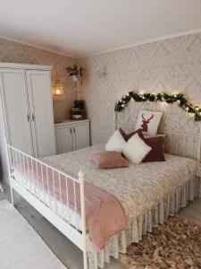 a bedroom with a bed with a garland on it at Holiday Home Kolka in Kolka +26 photos