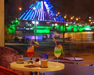 a table with drinks on it with a view of a street at Bamboo Green Riverside Hotel in Danang