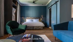 a bedroom with a bed and a couch and a chair at Labotessa Luxury Boutique Hotel in Cape Town