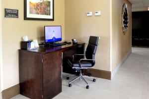 an office with a desk with a computer and a chair at Comfort Inn University Durham - Chapel Hill in Durham