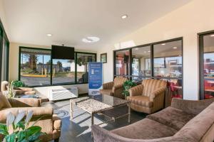 a waiting room with couches and chairs and a table at Econo Lodge Frederick I-70 in Frederick