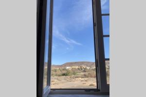 een raam in een kamer met uitzicht op de woestijn bij Apartamento en La Pared Fuerteventura vista mar in Pájara