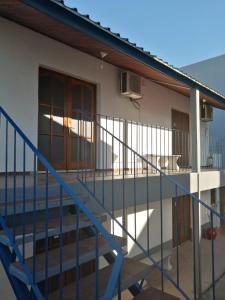 a house with a staircase leading to a balcony at POSADA SANTA CECILIA in Termas del Daymán