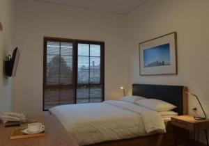A bed or beds in a room at Rumanami Residence