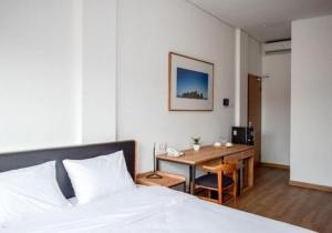 A bed or beds in a room at Rumanami Residence