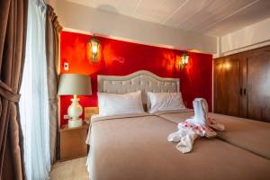 een slaapkamer met een groot bed met een rode muur bij @42 Residence in Bangkok