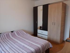 um quarto com uma cama e um armário de madeira em Ultracentral apartment bulevard regele mihai nr 10, sc a ap 16 em Timisoara