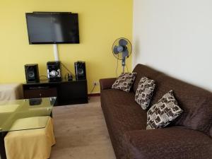 a living room with a couch and a flat screen tv at 4BR Quiet Apartment Miraflores Larcomar in Lima