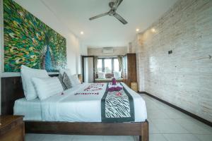 A bed or beds in a room at Iman Homestay Ubud