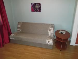 a couch and a table in a room at Hansa Apartment in Tallinn