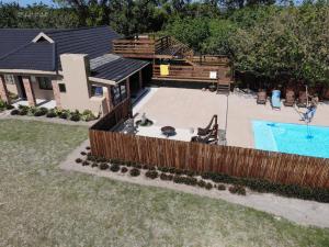 a backyard with a swimming pool and a wooden fence at Sibiya Guest House in Sodwana Bay