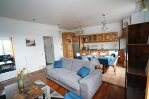 a living room with a couch and a table at T3 spacieux & cosy, climatisé, très proche Loire in Orléans +5 photos