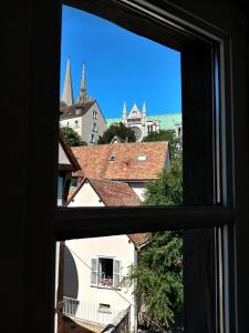 a view of a city from a window at Best of Chartres one bedroom city center and view on the Cathedral in Chartres