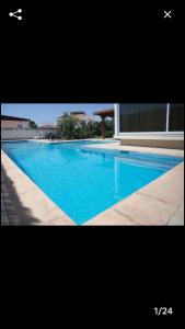 a large swimming pool with blue water in front of a building at Blue Lagoon with Pool in Eilat