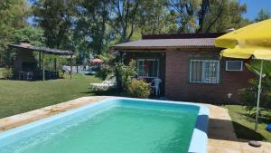 una piscina di fronte a una casa di cabañas LA COCA a Lobos