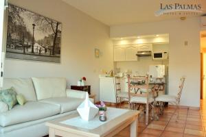 sala de estar y cocina con sofá y mesa en Suites Las Palmas en San José del Cabo