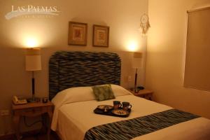 Suites Las Palmas tesisinde bir odada yatak veya yataklar
