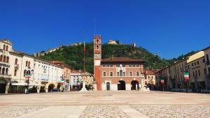 a building with a clock tower in the middle of a street at B&B Diana in Marostica