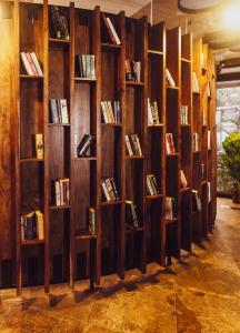 a wall of bookshelves filled with books at HALF Hotel, Calangute in Calangute