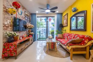 a living room with a red couch and yellow walls at Hoài Niệm Corner in Hanoi