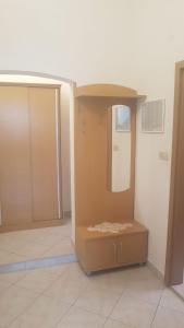 a room with a mirror and a brown cabinet at Apartments Jerković Drašnice-1bd in Drašnice