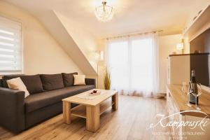 a living room with a couch and a table at Kampowski Apartments Deluxe in Bad Nauheim