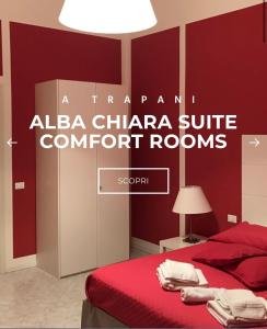 a red bedroom with a red bed and a lamp at AlbaChiara Suite Rooms - City Center in Trapani