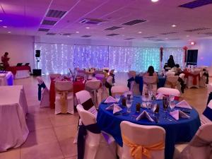 a banquet hall with tables and chairs and lights at Seis Playas Hotel in Tamarindo
