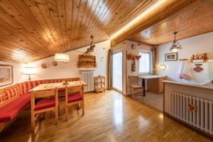 維哥迪法薩的住宿－Majon d'Aisciuda，客厅设有木制天花板和桌椅