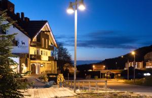 a street light in front of a building at night at Borgo Stalle in Prato Nevoso