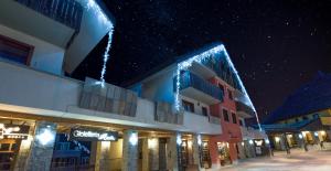 a building with lights on it at night at Borgo Stalle in Prato Nevoso +31 photos