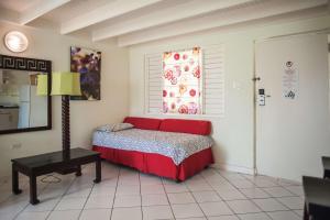 a bedroom with a red bed and a window at Mystic Ridge Resort in Ocho Rios