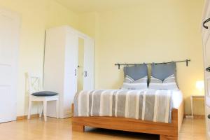 a bedroom with a bed and a table in it at Ferienwohnungen Domblick-Herkenrath in Bergisch Gladbach