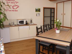 a kitchen and dining room with a table and chairs at Le bois du drillais in La Gaubretière +2 photos