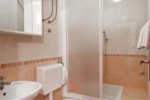 a bathroom with a shower and a toilet and a sink at Promenada - Beachfront Apartments in Tučepi +31 photos