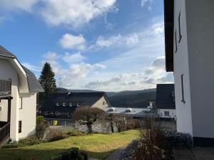 a view of a town with houses and mountains at Winterberger Lodge in Winterberg